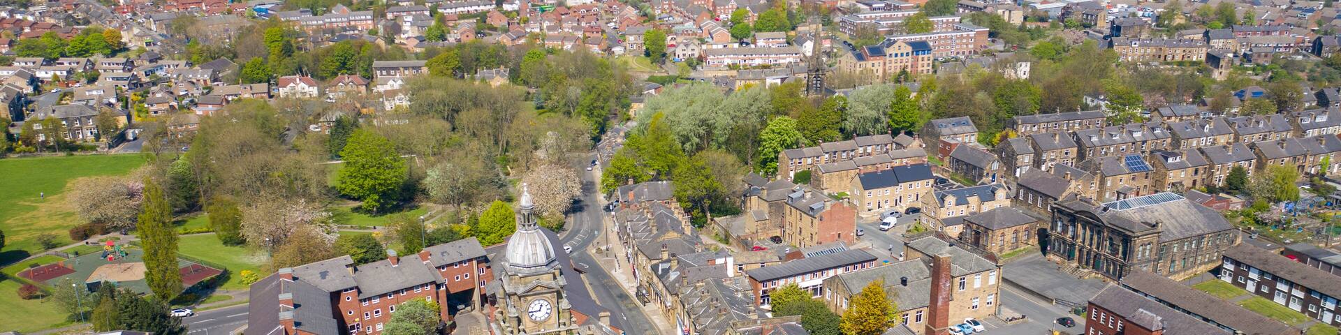 Aerial photo of the village of Morley in Leeds, West Yorkshire in the UK, showing an aerial drone view of the main street and historical old town hall and clock tower