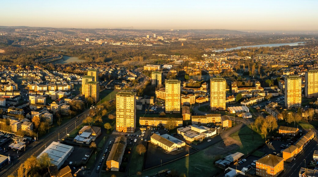 Aerial view of residential neighborhood with river, roads, and trees at sunset, Watsonville, Motherwell, United Kingdom.