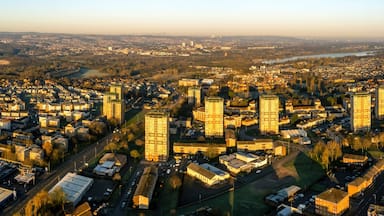Aerial view of residential neighborhood with river, roads, and trees at sunset, Watsonville, Motherwell, United Kingdom.