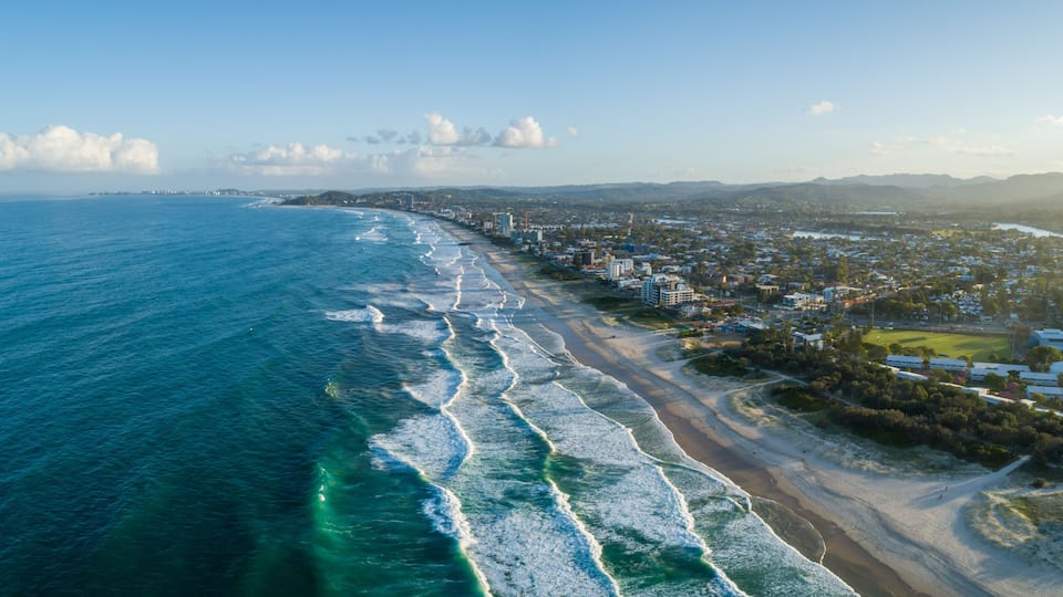 Aerial panorama of Palm Beach suburb and ocean coastline at sunset. Gold Coast, Queensland, Australia