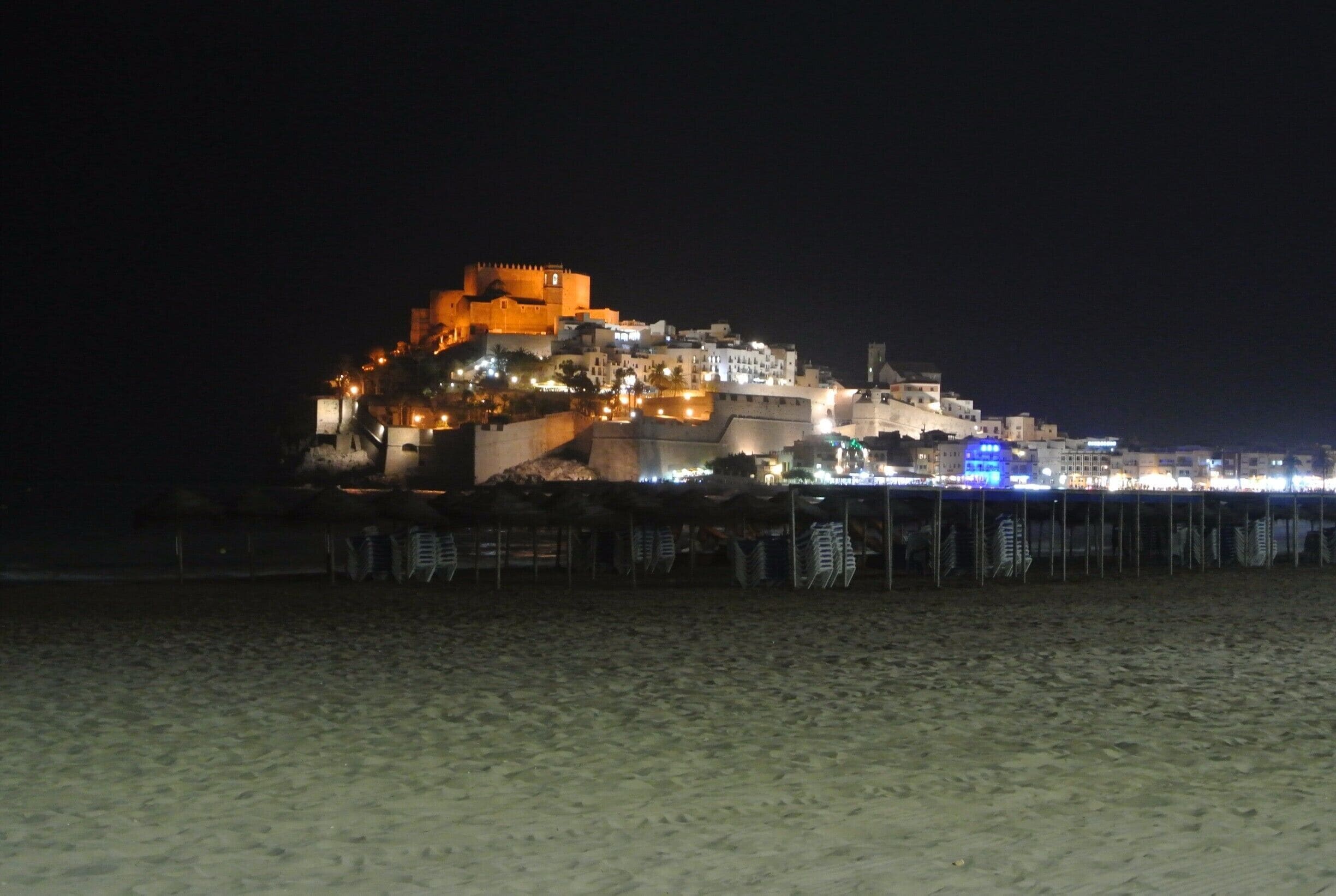 Night life in Peñíscola, Spain, is just amazing; specially up the castello where loads of beautiful shops will make you stop to buy a cute souvenir.
I was there in summer and there were so many options for late dinner, great cocktails and shopping. 
Seafood in the Spanish coast is just amazing, try the octopus!
A walk throughout the beach by night is a must.