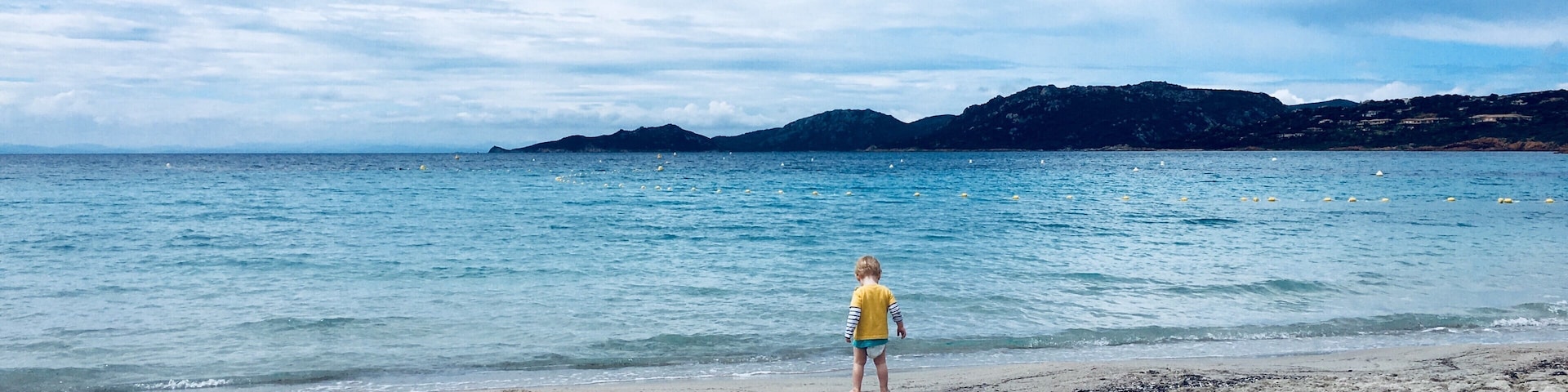 This was my two year old son's first visit to a beach. Having never been overly keen in water, he was fascinated with the beautiful aquamarine sea and wandered straight over to explore. We had a wonderful morning splashing around in the water as the clouds cleared and will always remember this moment. 
Top tip: there's one point of entry, turn left from the restaurant and you'll find the clearest part of the sea, not a stone in sight. 
#LifeAtExpedia