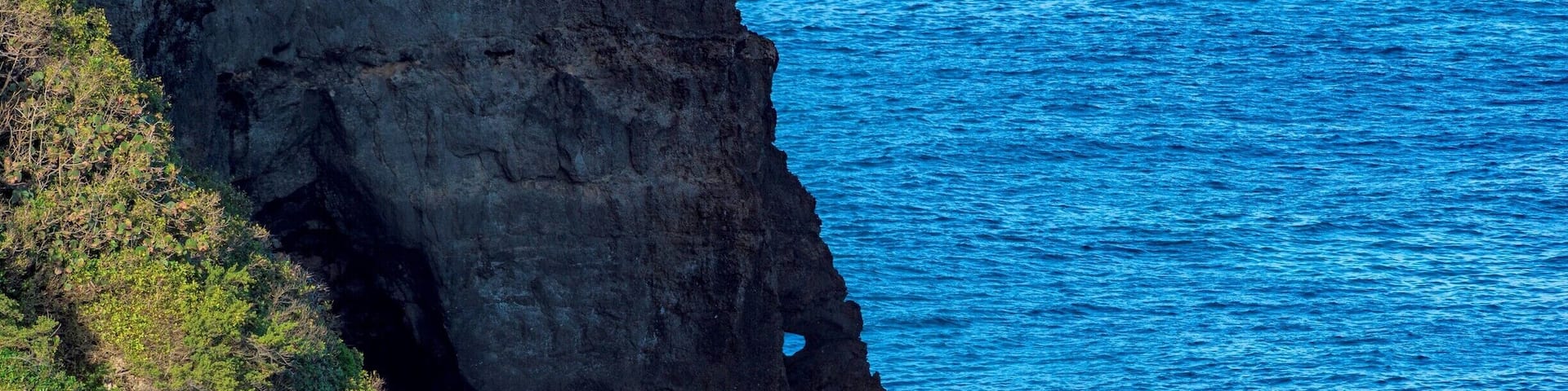 This "Game of Thrones" Rock can be seen from a hidden staircase that leads down to a secluded beach. To get to the staircase you enter a field from street level and work your way down "the sketchy" staircase. Enjoy finding it.