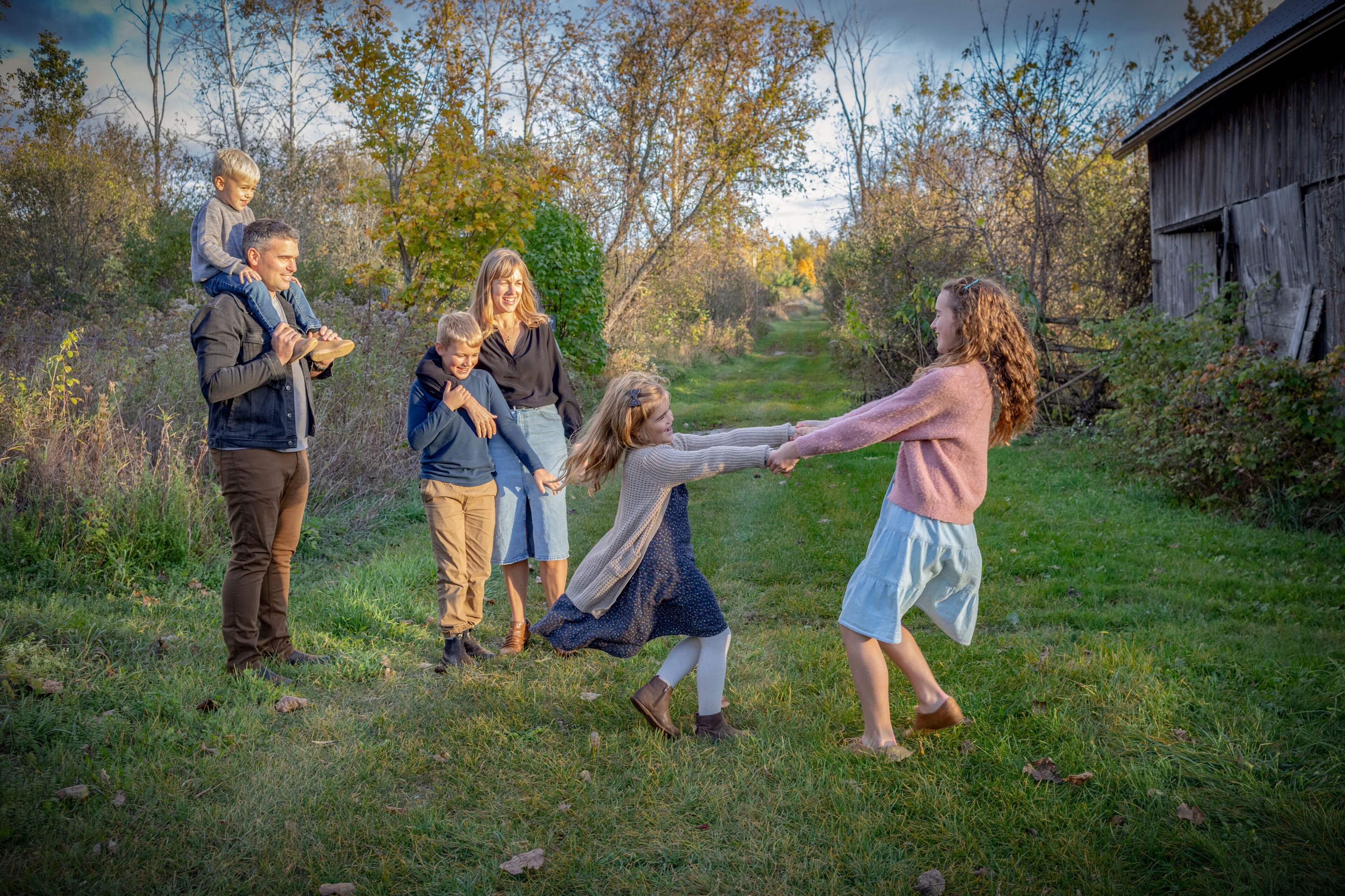 Family enjoying an outing together, going for a walk and playing in a rural setting in Beckwith Township at Carleton Place in the Ottawa Valley; Ontario, Canada