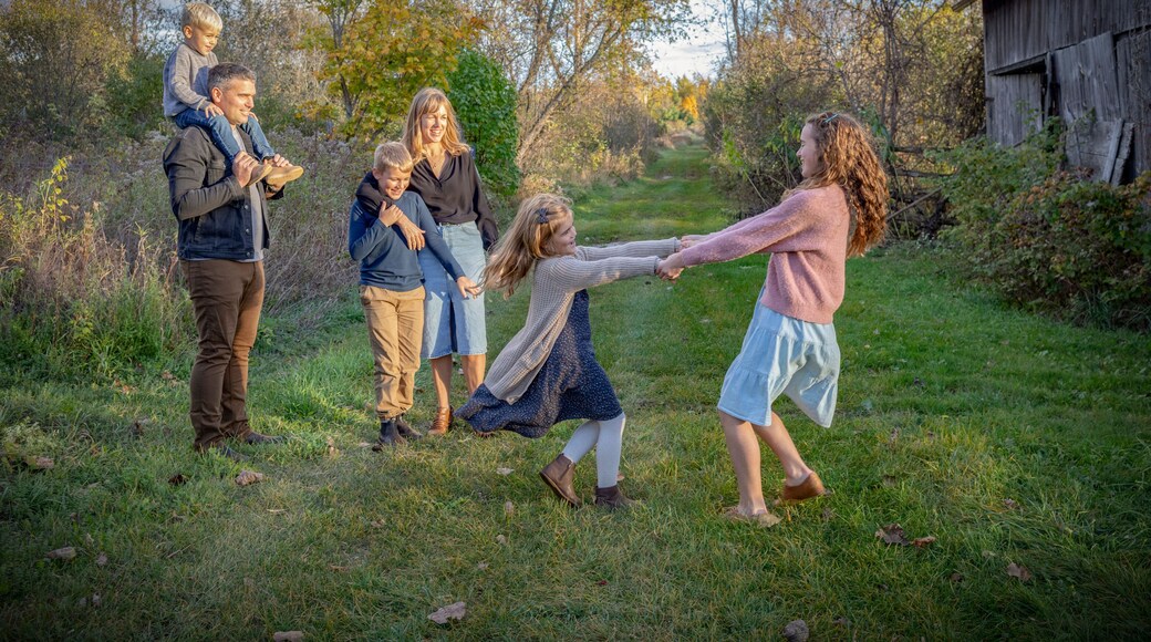 Family enjoying an outing together, going for a walk and playing in a rural setting in Beckwith Township at Carleton Place in the Ottawa Valley; Ontario, Canada