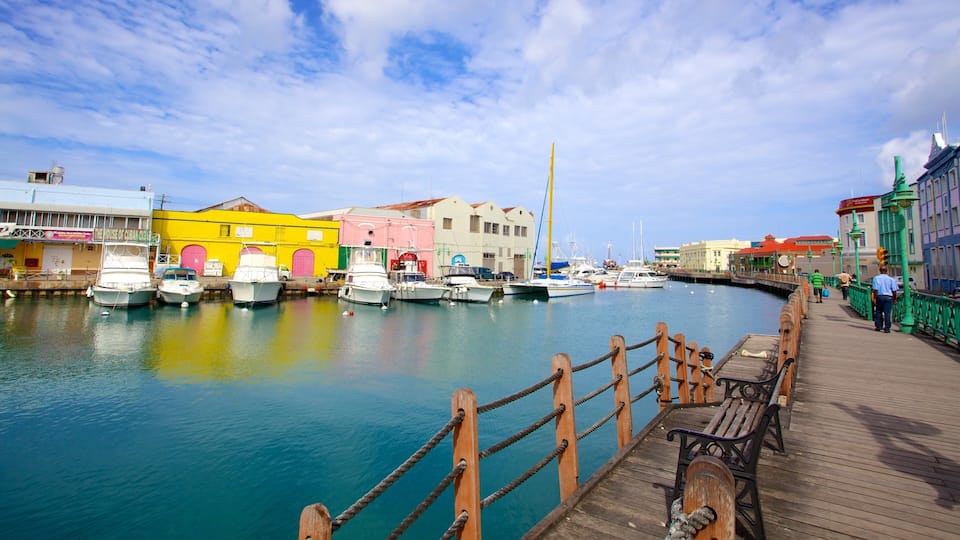 A colorful waterfront with boats docked, a wooden pier, and buildings with vibrant facades.