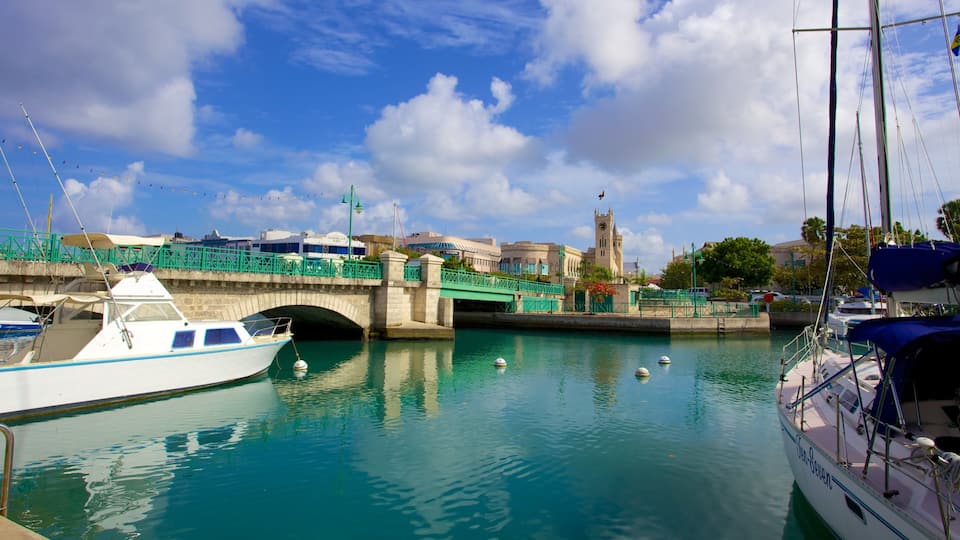 A harbor with boats, a bridge, and a clock tower.