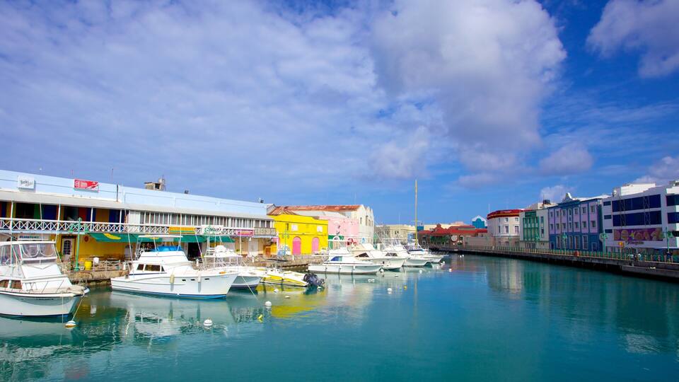 A marina with colorful buildings and boats docked in calm waters.
