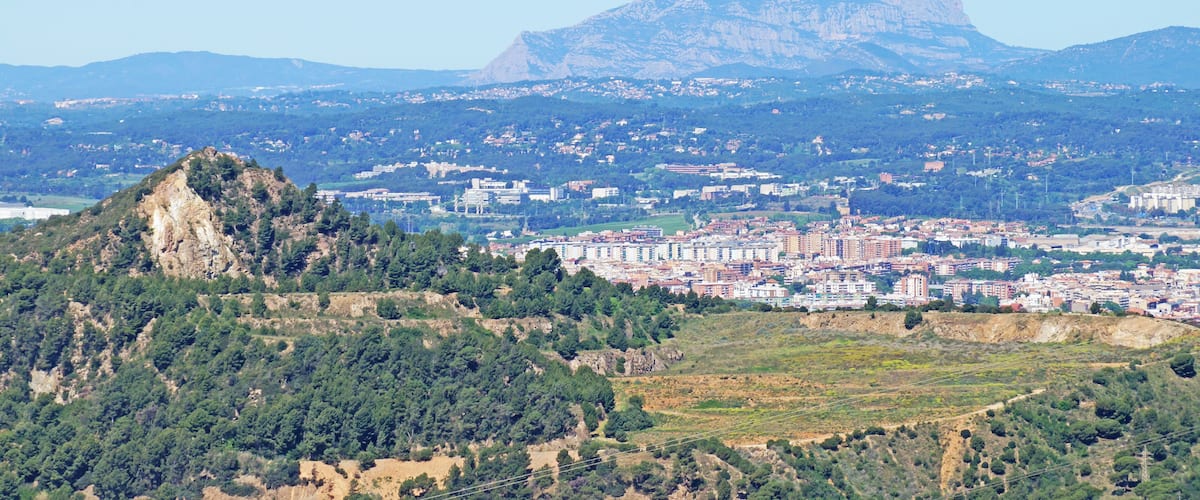 A city with a prominent mountain in the background.