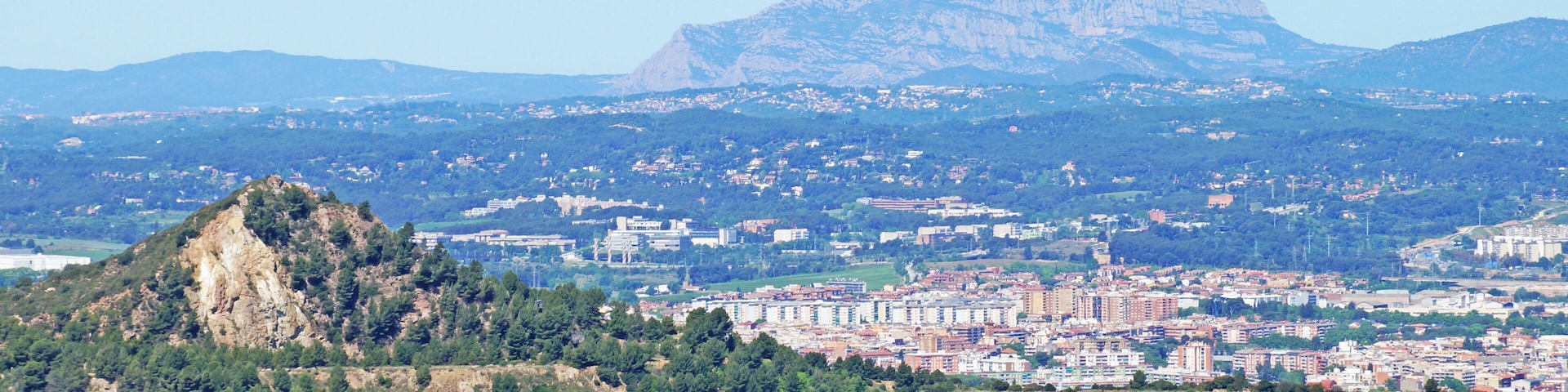 A city with a prominent mountain in the background.