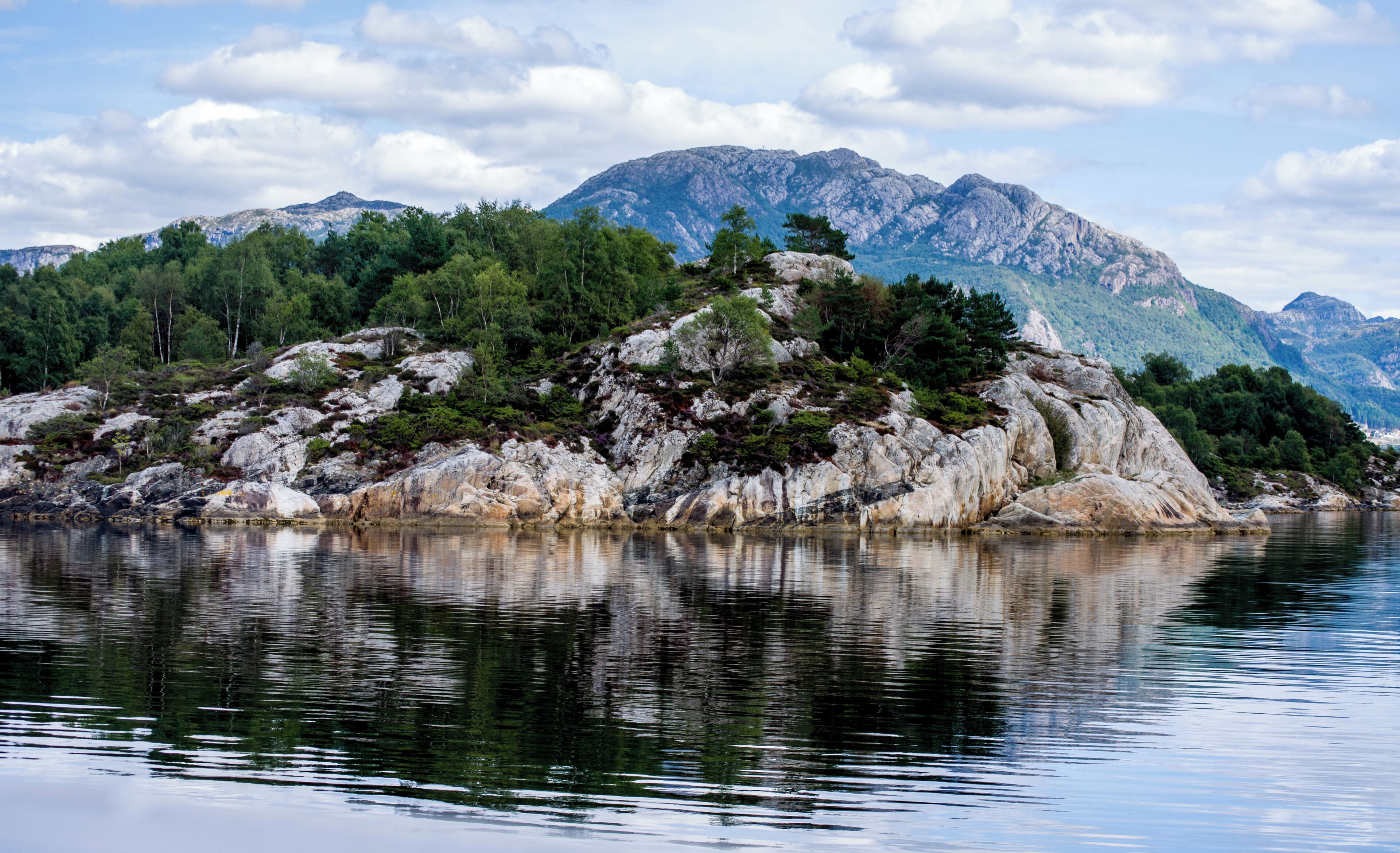 Heading from Stavanger to Pulpit Rock you pass a series of small islands with a mountain backdrop.