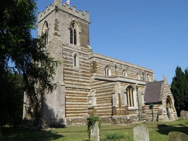 A historic stone church with a tower and arched windows.