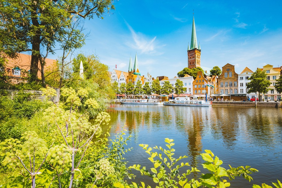 Classic panorama view of the historic city of Luebeck with famous Trave river in summer, Schleswig-Holstein, Germany, Shutterstock ID 1193452930, Purchase Order: SP-1506 Go Guides, Order Number: , Cli