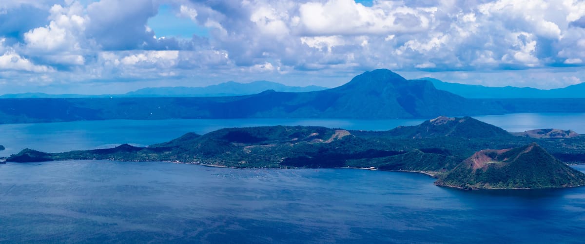 A coastal landscape with multiple islands and a prominent mountain in the background.