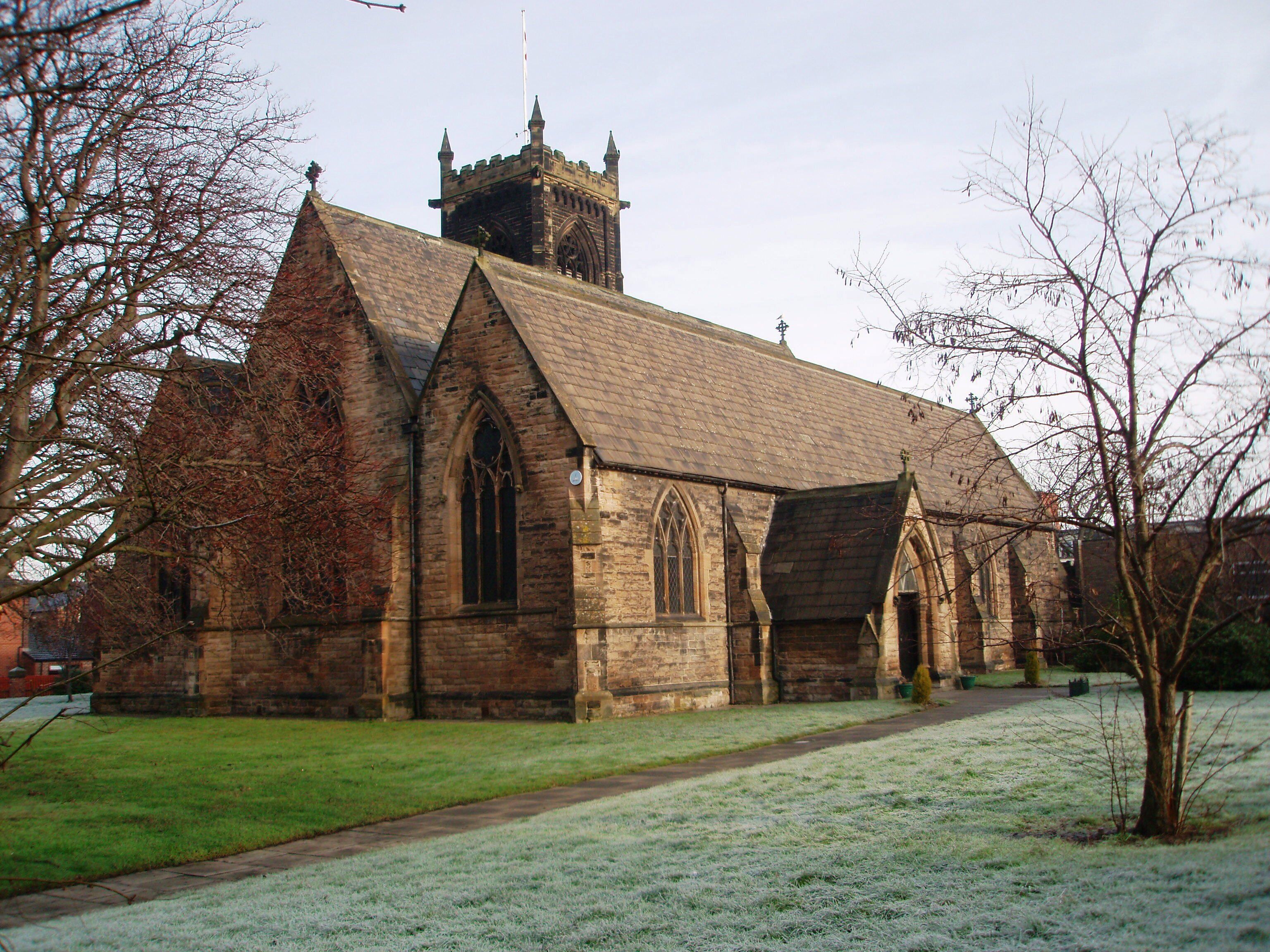 A historic church with a prominent tower and pointed arches.