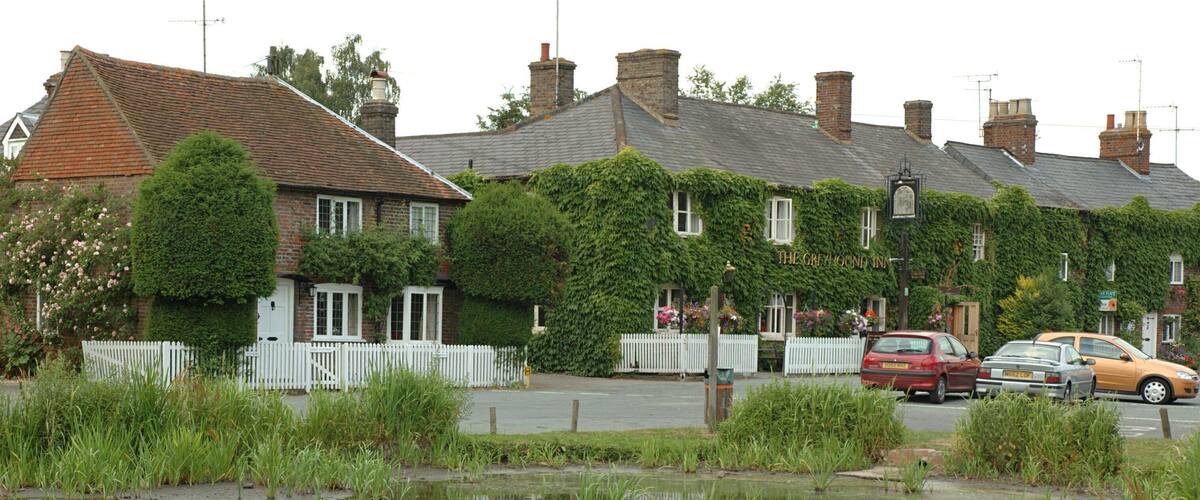 The pond in Aldbury with the Greyhound Inn in the background. Hertfordshire, England, UK.