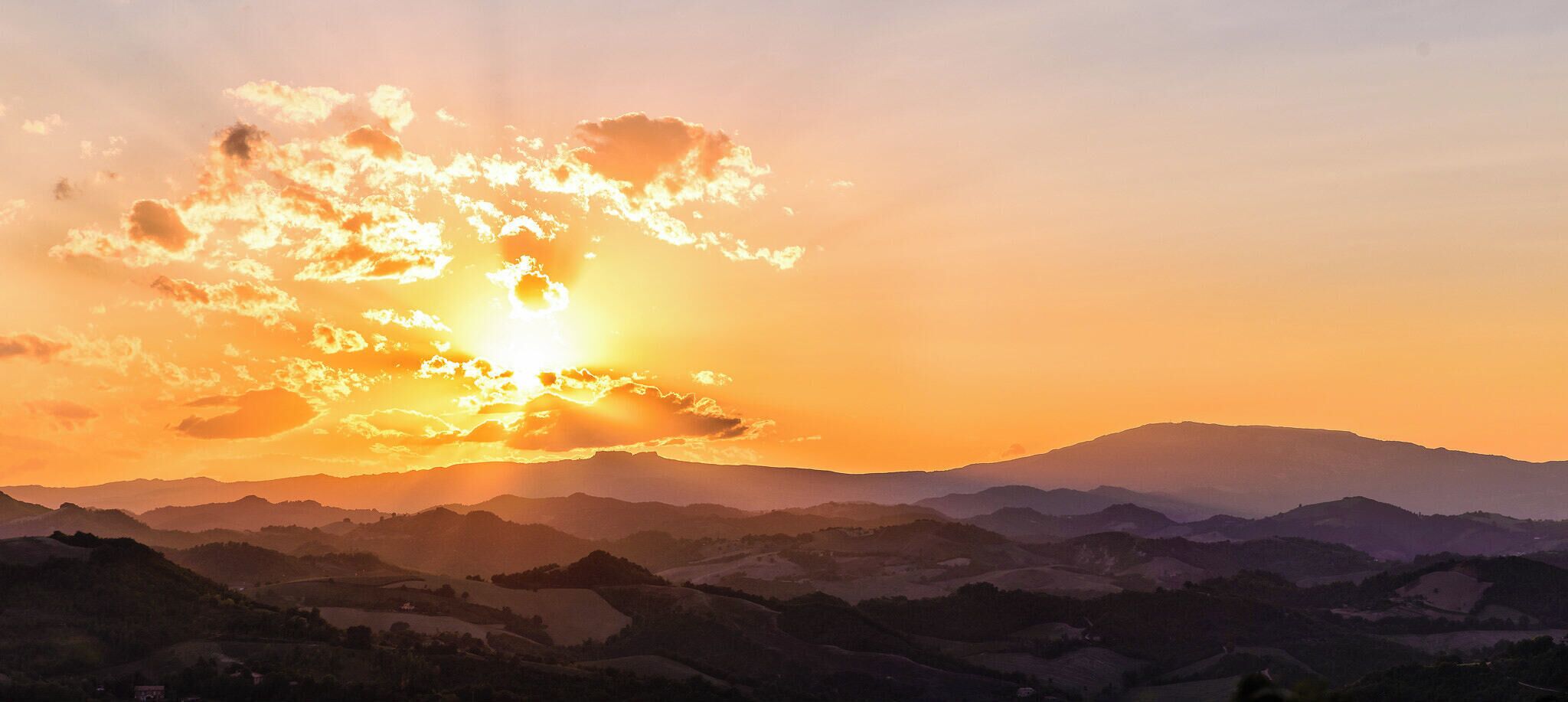500px provided description: Every evening can be a gift, unexpected. The only way to catch them all is to always carry the DSLR with you; which you cannot.. but this time I had it, I was lucky, and I got this! Hope you like it. [#sky ,#sunset ,#mountains ,#sun ,#clouds ,#italy ,#evening ,#rays ,#italia ,#hills ,#sera ,#tramonto ,#marche ,#urbino ,#Nikon ,#Tamron 24-70 ,#D610 ,#marco montagna]