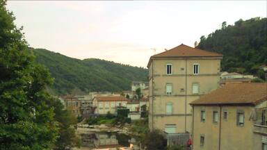 A river flowing through a town with buildings on both sides.