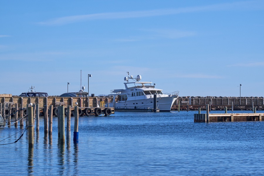 Single motor boat moored at Vedbaek Harbor in Denmark, on a cold sunny winter day