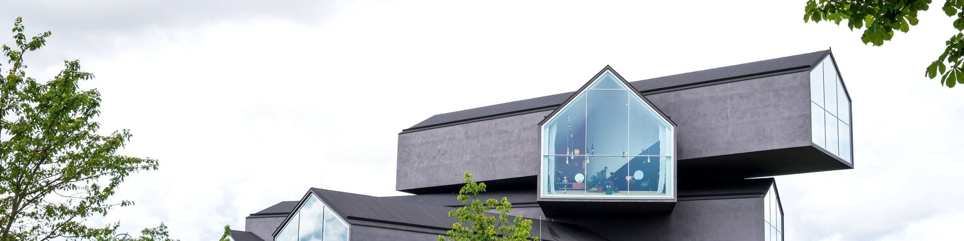 A modern building with large windows and a unique architectural design.