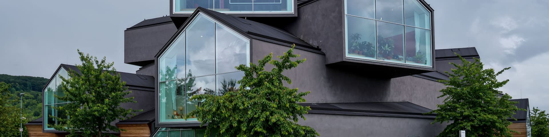 A modern building with large glass windows and a unique geometric design.