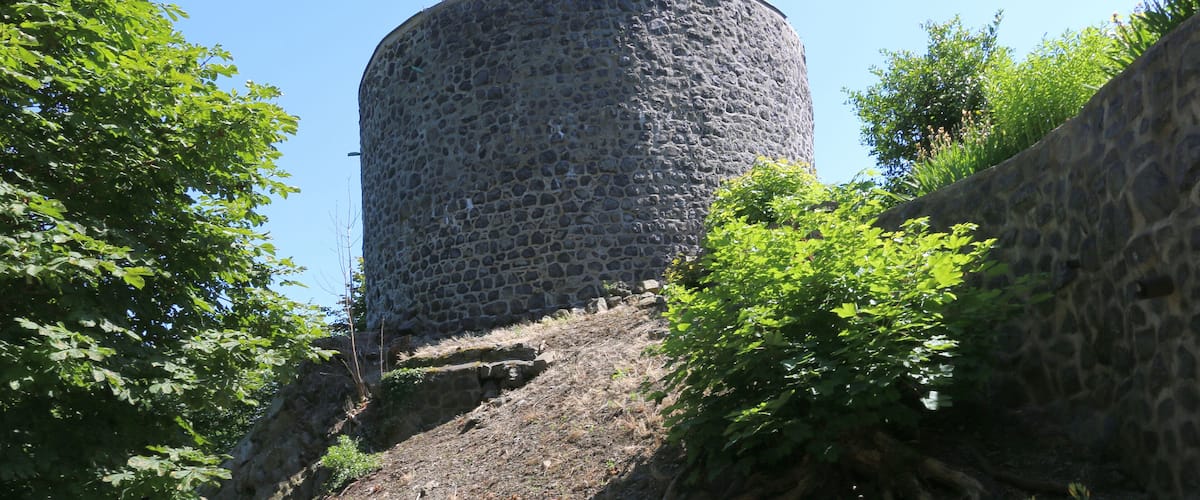 A stone tower surrounded by trees.