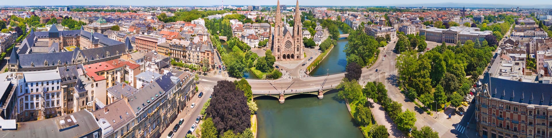 A cityscape with a prominent cathedral, a river, and a bridge.