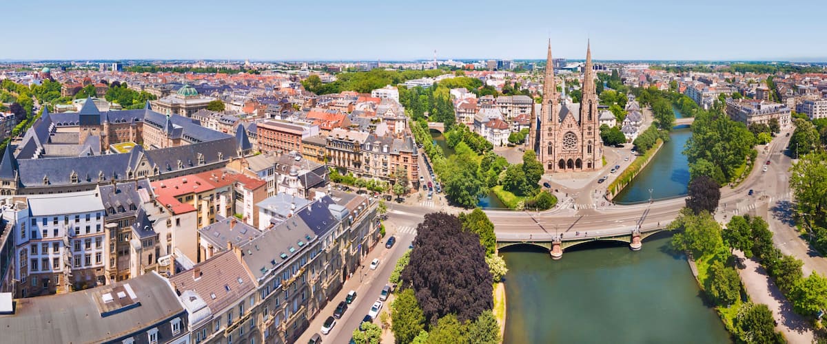 A cityscape with a prominent cathedral, a river, and a bridge.