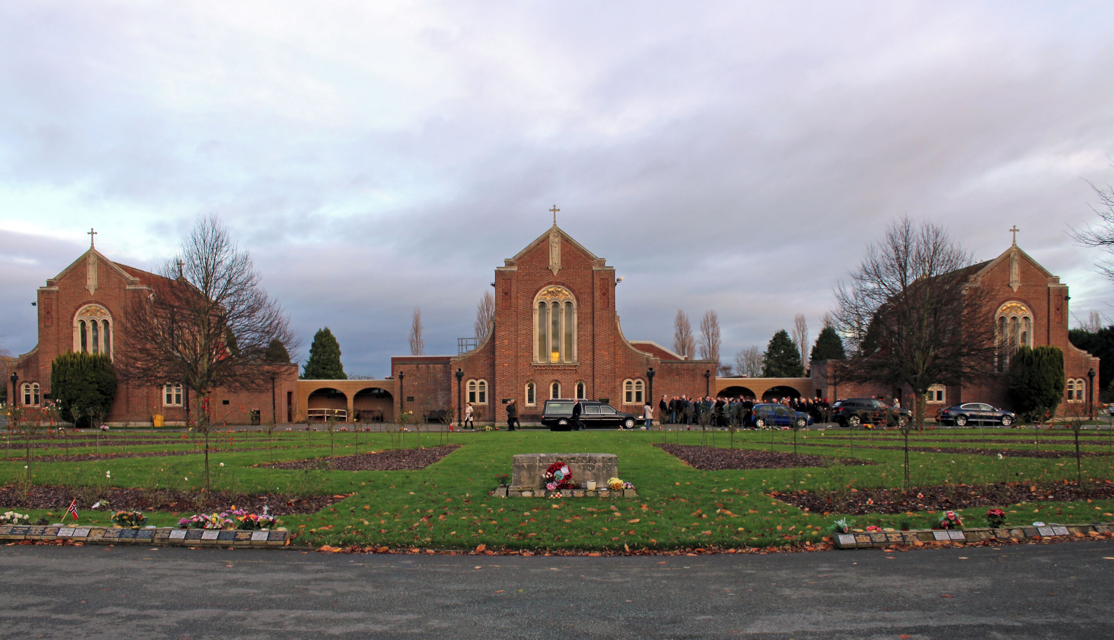 View east across the rose garden to the three chapels; north chapel to the left and then central and south chapels.