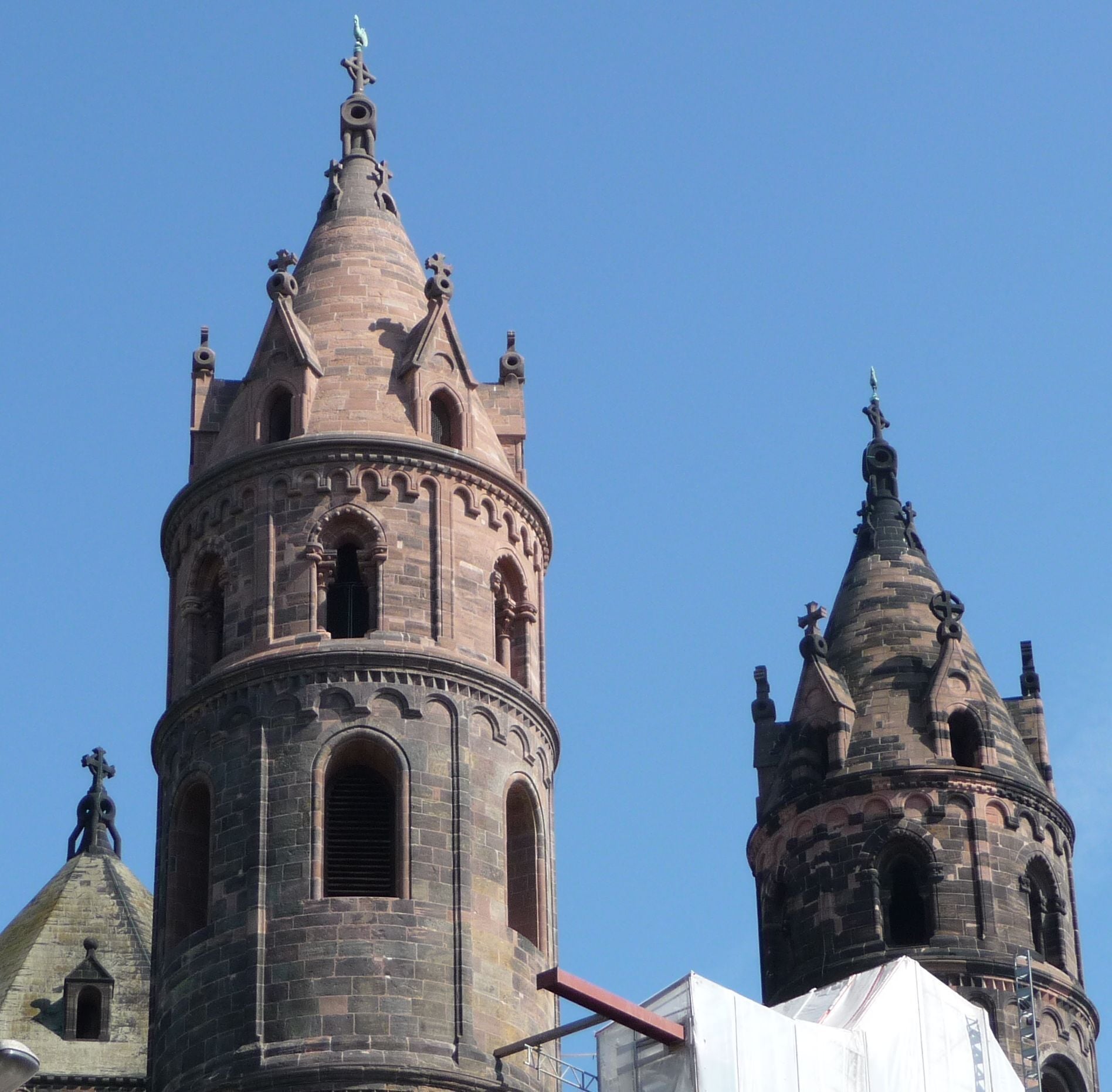 A historic church with a prominent bell tower and a smaller spire.