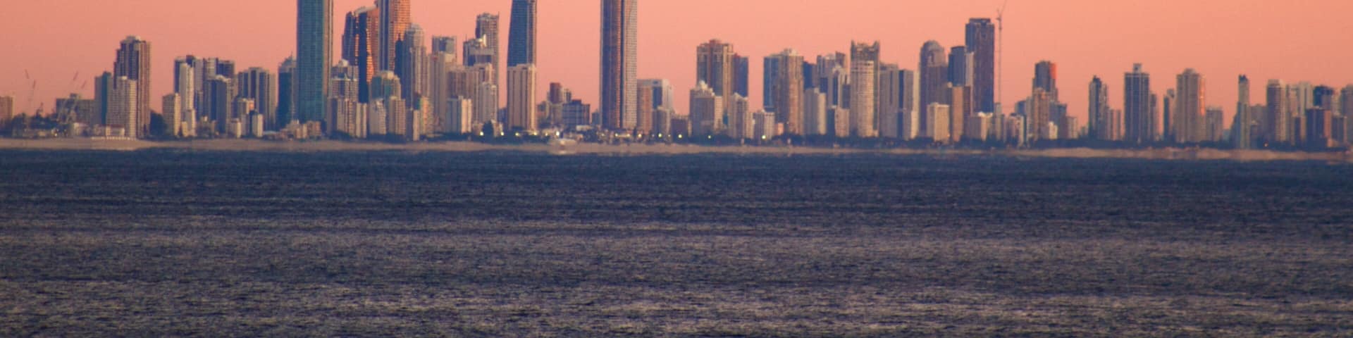 Coolangatta which includes a high rise building, a city and a sunset