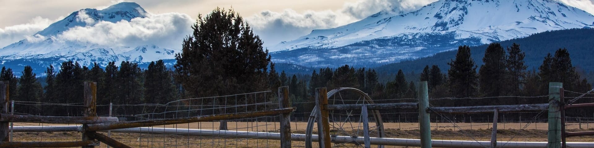 The Three Sisters. North Sister to the right, South Sister to the left, and the Middle Sister is just barely visible as a tuft of cloud on the south slope (left) of the North Sister.