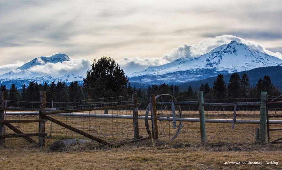 The Three Sisters. North Sister to the right, South Sister to the left, and the Middle Sister is just barely visible as a tuft of cloud on the south slope (left) of the North Sister.