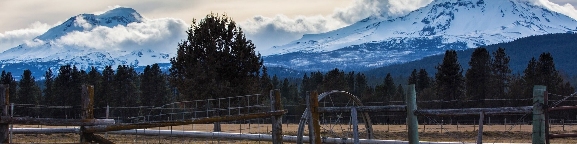 The Three Sisters.  North Sister to the right, South Sister to the left, and the Middle Sister is just barely visible as a tuft of cloud on the south slope (left) of the North Sister.