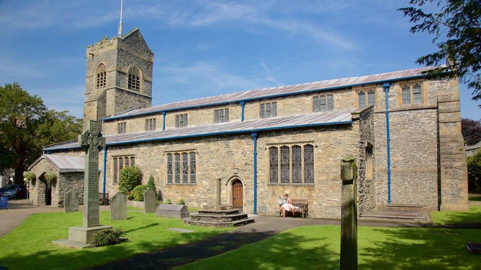 A stone church with a tower and stained glass windows.