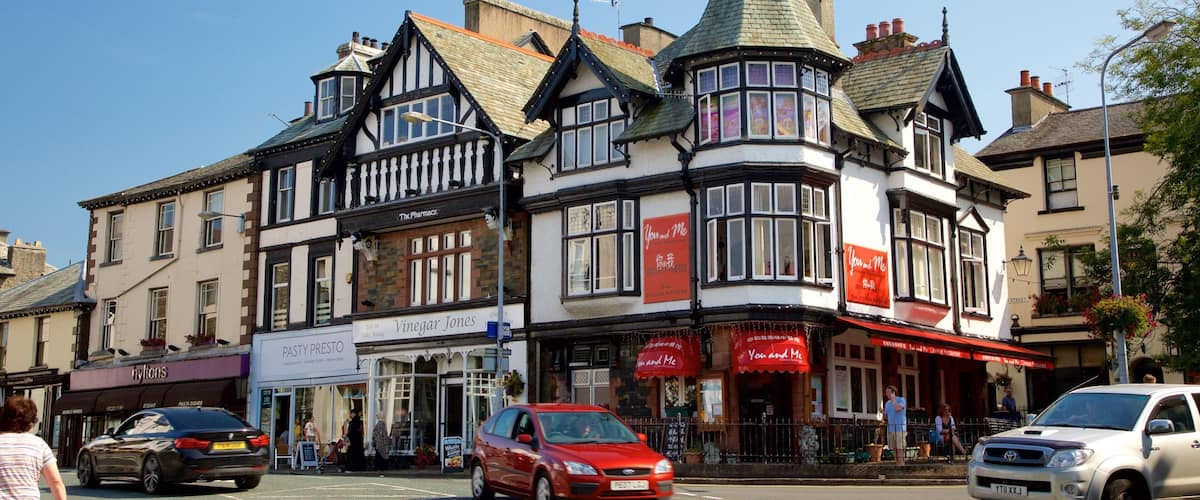 A traditional pub with a corner turret and a red awning.
