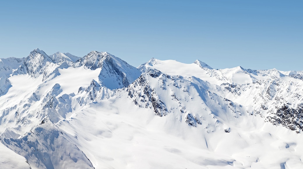 A snow-covered mountain range with sharp peaks and ridges.