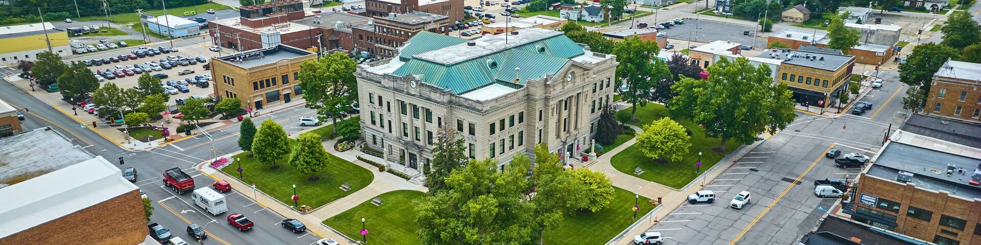 Aerial downtown Auburn Indiana courthouse with green lawn