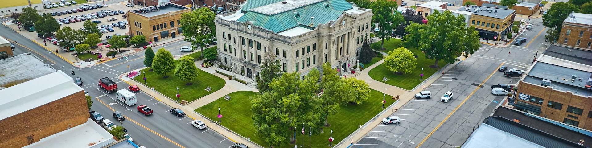 Aerial downtown Auburn Indiana courthouse with green lawn