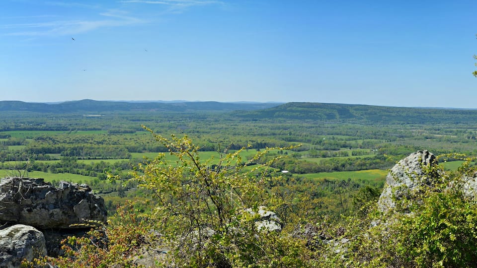 A mountainous landscape with rocky outcrops and a valley.