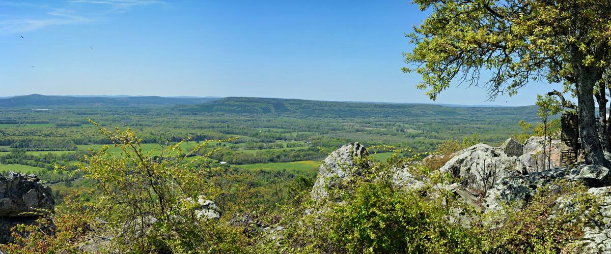 A mountainous landscape with rocky outcrops and a valley.