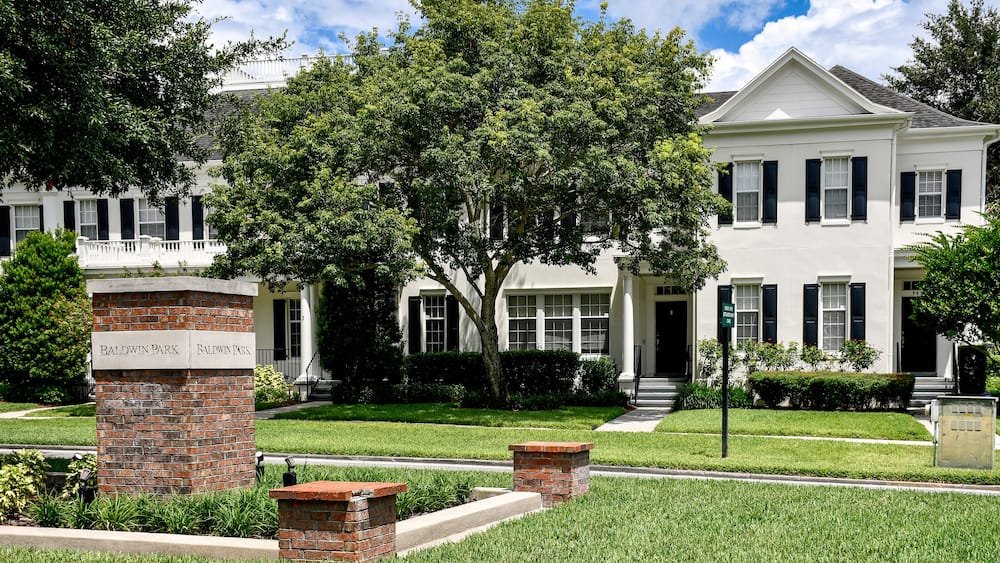 Entrance sign at Baldwin Park in Orlando, Florida. A tranquil, primarily residential community with tree-lined streets featuring quaint cafes, restaurants, bars, and shops.