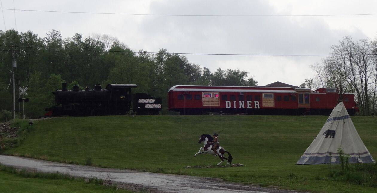 This place is definitely unique. It can be easy to miss because it's set back off the road a bit, but you'll for sure know it when you see it. Located on top of a hill inside of an old train car with the engine attached. The decor is Ohio State Buckeyes merch overload with a smattering of railroad memorabilia.  

The menu is fairly burger-centric (no arguments here).

In need of a light meal? Try the Buckeye Belly Buster!

8lbs of Hamburger
1lb of Bacon
Salami
Pepperoni
American and Swiss Cheese
Grilled Mushrooms
Grilled Onions
Lettuce
Tomatoes
And Woody Sauce, clocking in at just over 10 pounds!