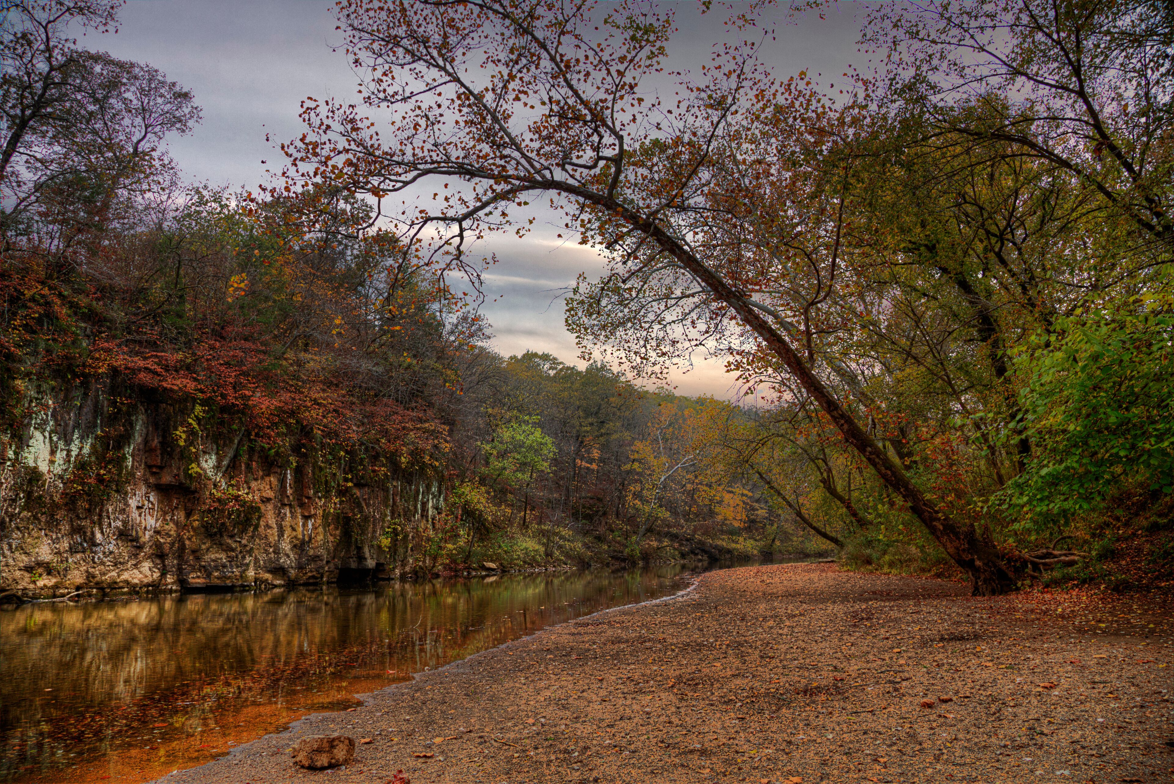 Beauty of the Unfolding  Autumn.  Big River  St. Francois State Park 8920 US Highway 67,  Bonne Terre, MO   A bluff forms an impenetrable  wall to the movement of water