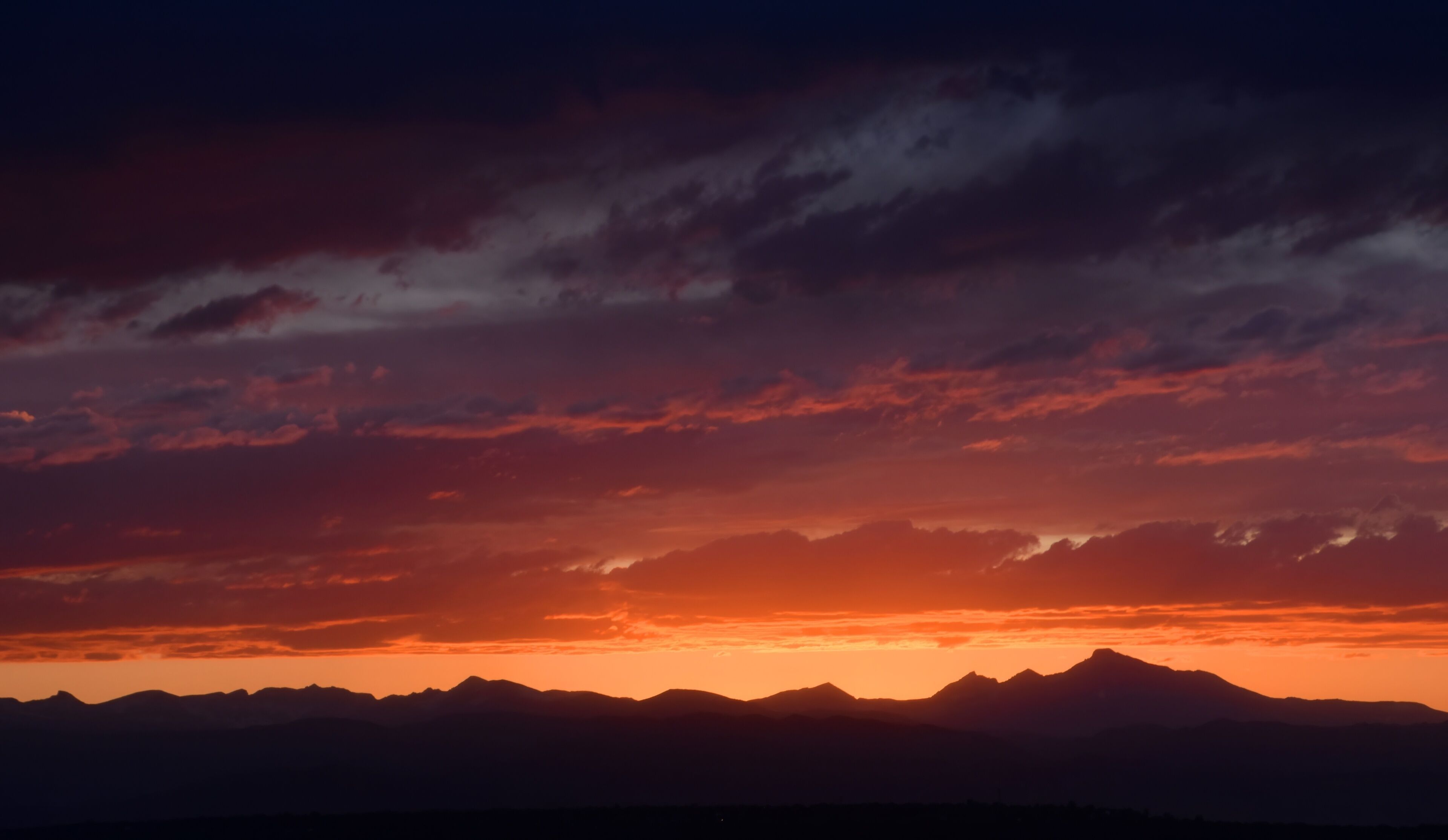 colorful Summer sunset over  long's peak and the front range of the  Rocky Mountains of colorado, as seen from Broomfield, colorado 