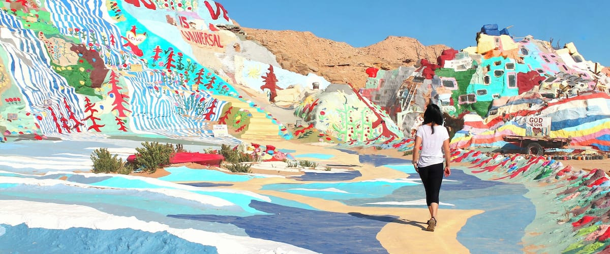 A colorful landscape with a person walking.