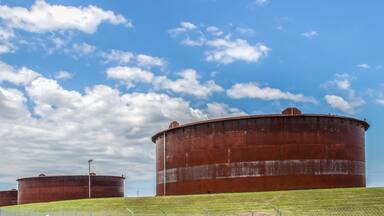 Huge rusty storage tanks full of petroleum products in tank farm in Cushing Oklahoma where most oil in USA is stored and traded
