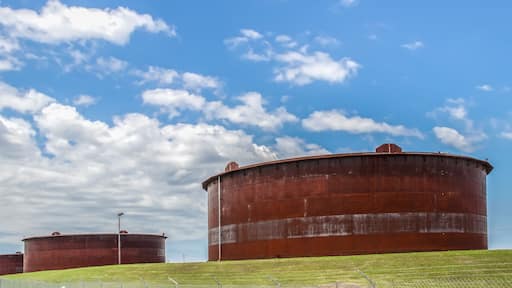 Huge rusty storage tanks full of petroleum products in tank farm in Cushing Oklahoma where most oil in USA is stored and traded