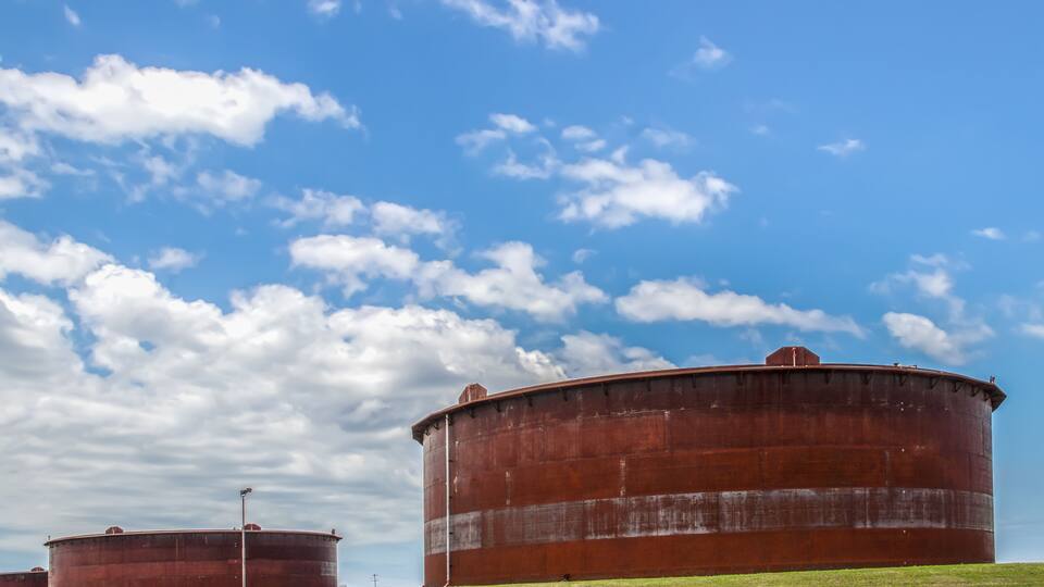 Huge rusty storage tanks full of petroleum products in tank farm in Cushing Oklahoma where most oil in USA is stored and traded