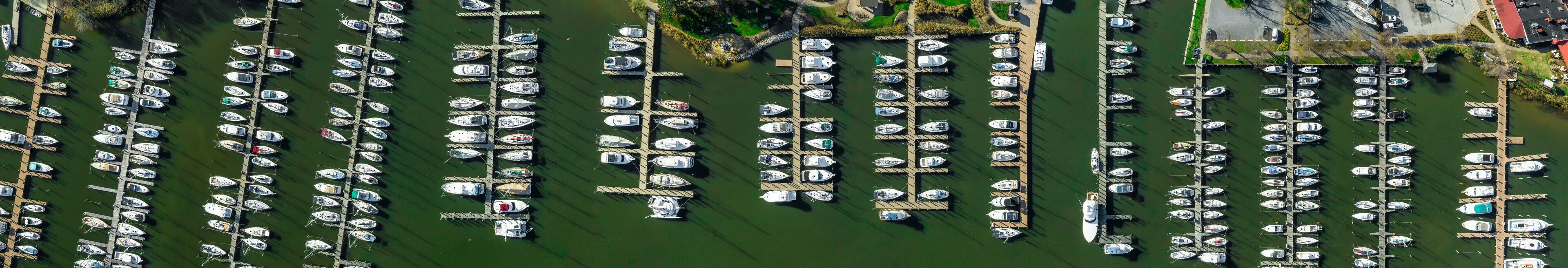 Aerial panorama of Deale  waterfront docks on the Western Shore of Chesapeake Bay Maryland, with rows of of luxury sailboats docking in the marina.  